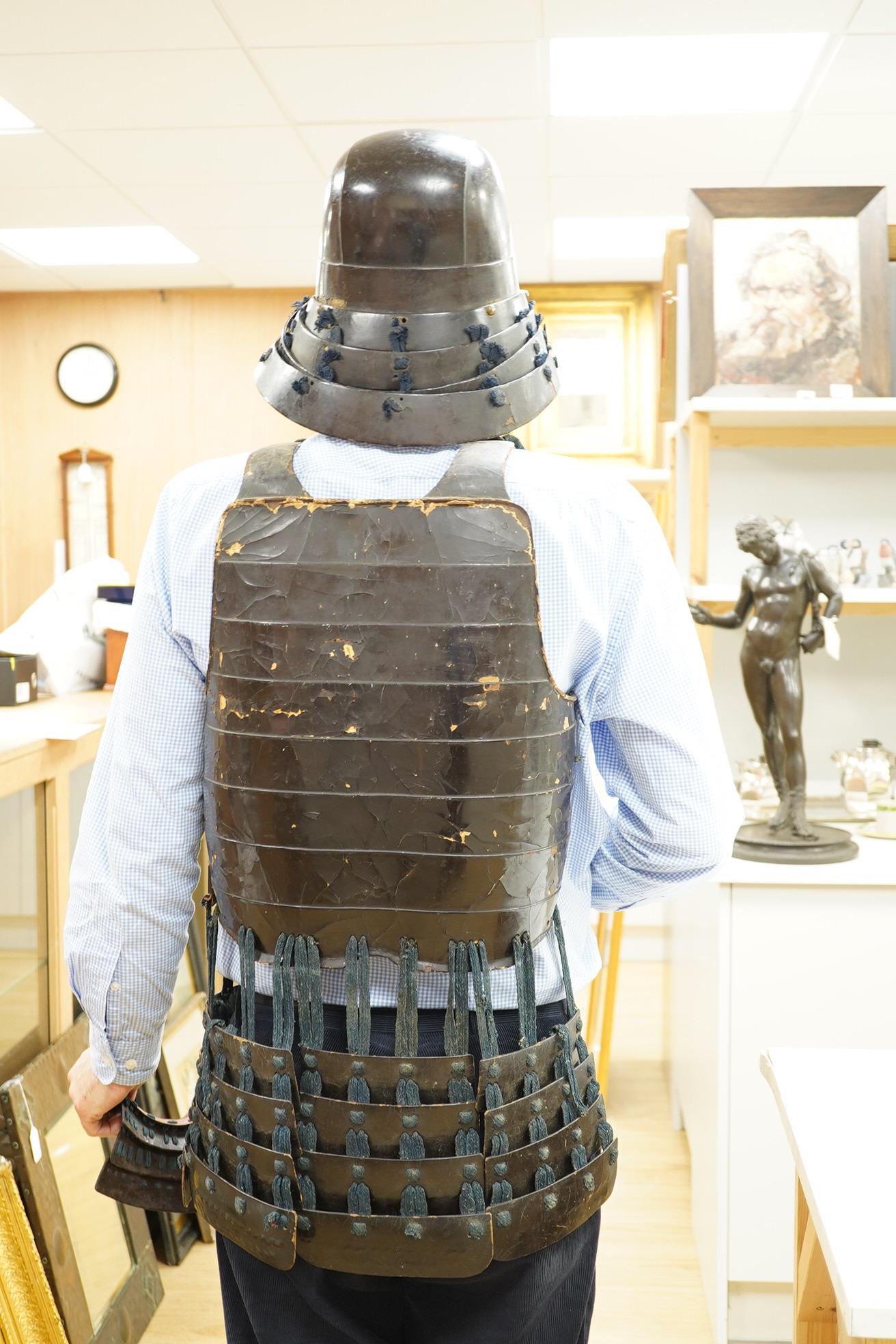 A Japanese armour, 19th century or earlier comprising; helmet Kabuto of five plates covered in black lacquer with 4-plate shikoro, also an iron lacquered mempo with three lames to throat and a do opening at side, embosse